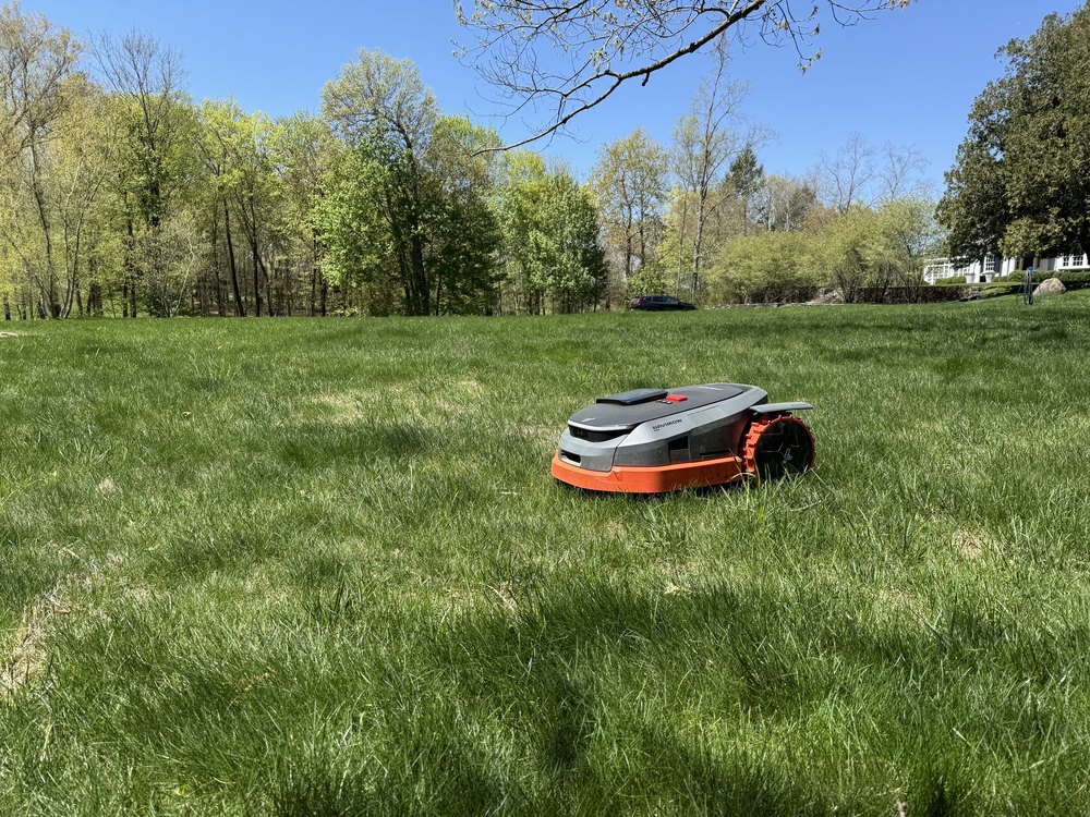 Segway Navimow on a wide open Connecticut lawn under blue sky